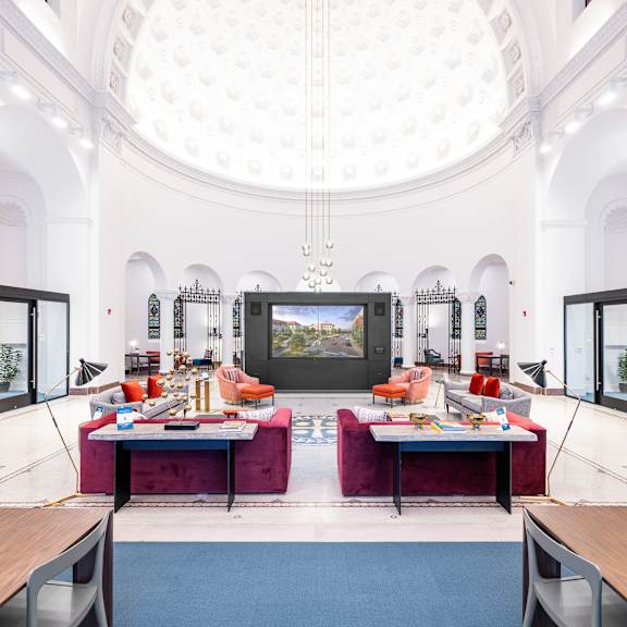A room with a white ceiling and a large screen on the wall.