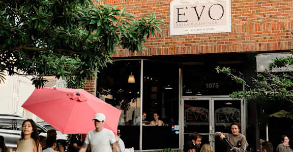 people outside of a restaurant with a red umbrella at The Teale Navy Yard, North Charleston, SC, 29405