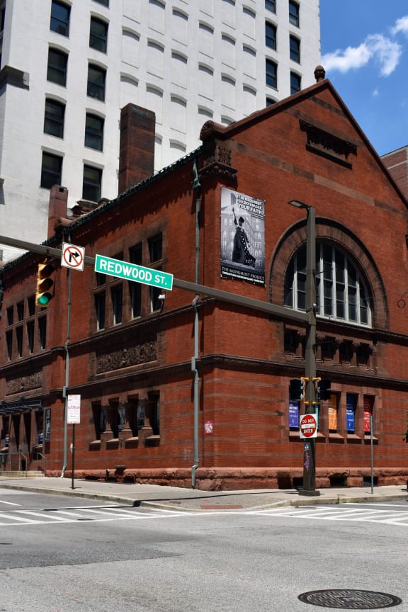 a red brick building on the corner of a city street