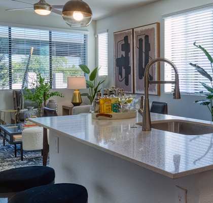 a kitchen with an island and a stove and a microwave