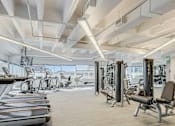 Thumbnail 9 of 19 - A spacious gym with treadmills, elliptical machines, and other exercise equipment.