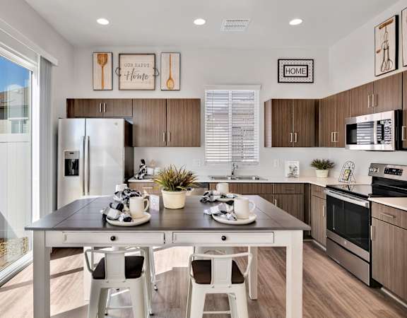 a kitchen with stainless steel appliances and a table with chairs at Parke Place, Prescott Valley, Arizona