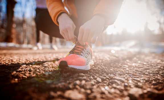 a person tying their running shoe at Estate at Woodmen Ridge, Colorado Springs Colorado