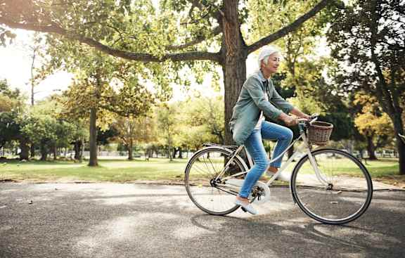 A person riding a bicycle in a park.