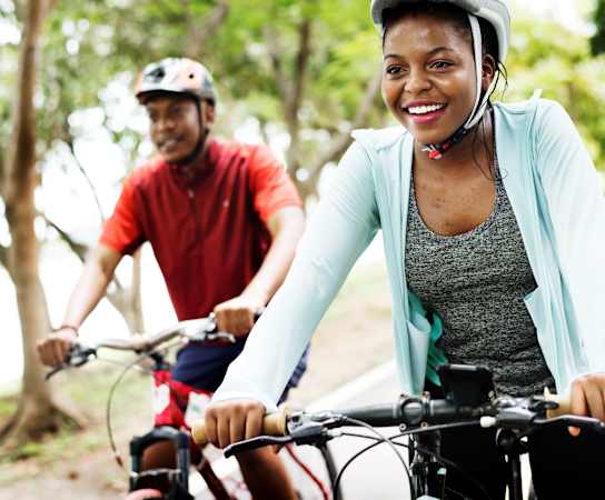 a woman and a man riding bikes at Maven on Broadway, Rochester, 55904