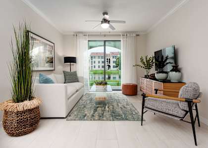 a living room with a white couch and a green rug at The Atlantic Palms  at The Atlantic Palms at Tradition, Port St Lucie, FL, 34987