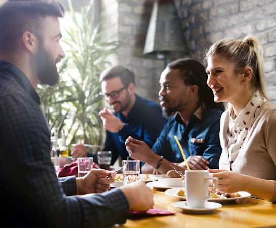 people sitting around a table in a restaurant at High Oaks, Austin, Texas