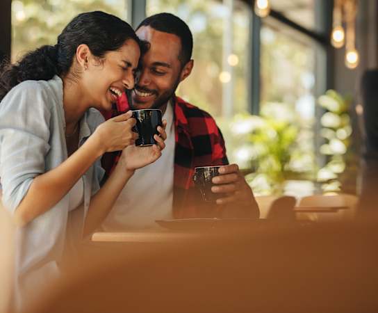 a couple sitting at a table in a restaurant drinking coffee at Stonelake at the Arboretum, Texas, 78759