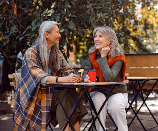 two women sitting at a table in a park at Maven on Broadway, Rochester, 55904