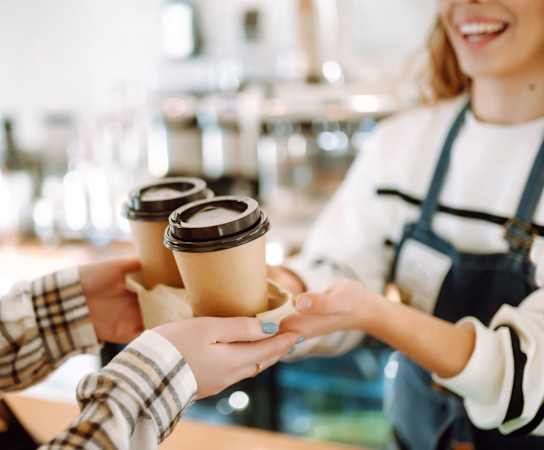 people holding up cups of coffee in a coffee shopat Bella Vista on Park, Florida, 33563