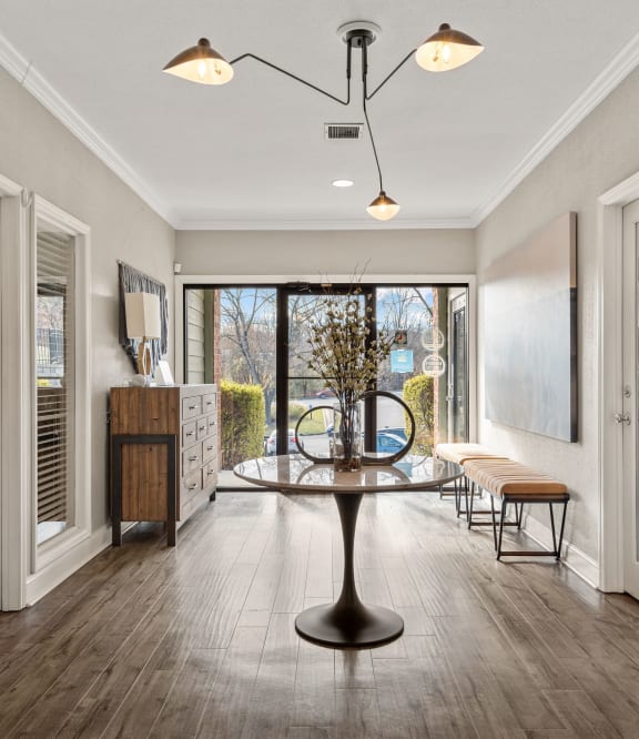 a living room with three mirrors and a wood floor