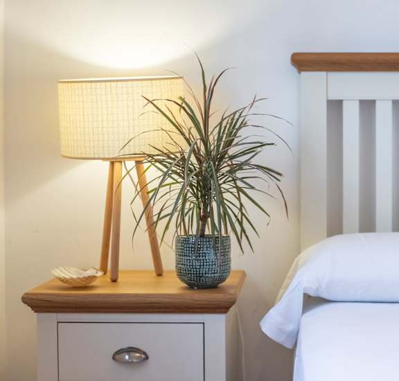 a bedroom with a bed and a nightstand with a lamp at Northland at the Arboretum, Austin, Texas