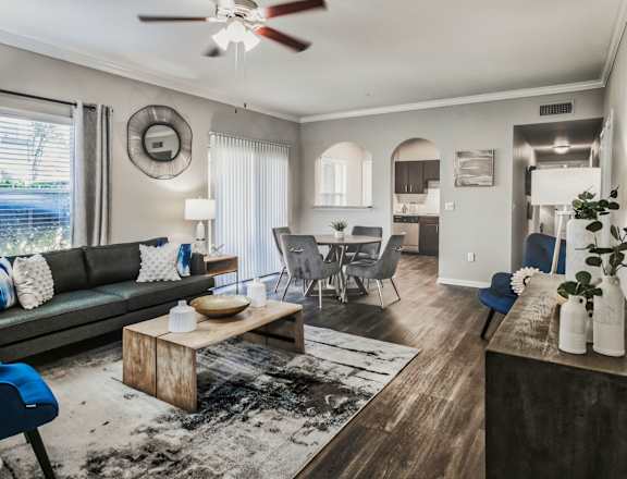 A living room with a couch, chairs, and a coffee table.