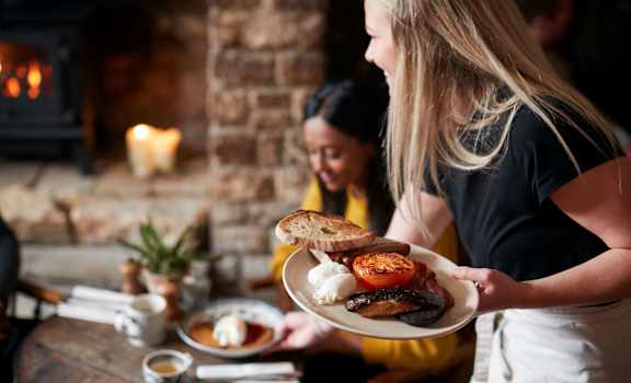 a woman holding a plate of food at Saddleworth Green, Florida