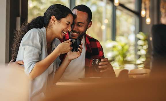 a couple sitting at a table in a restaurant drinking coffee at Via Lugano, Boynton Beach, FL
