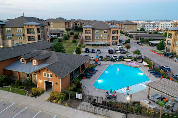 A swimming pool in a residential area surrounded by apartment buildings at Walker Place Apartments, Texas, 76643