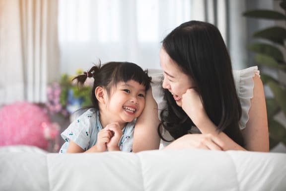 Mother and daughter smiling