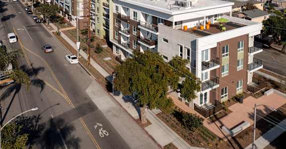 an aerial view of an apartment building on a city street