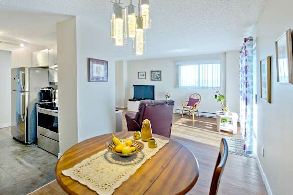 A kitchen with a table in the middle of it.