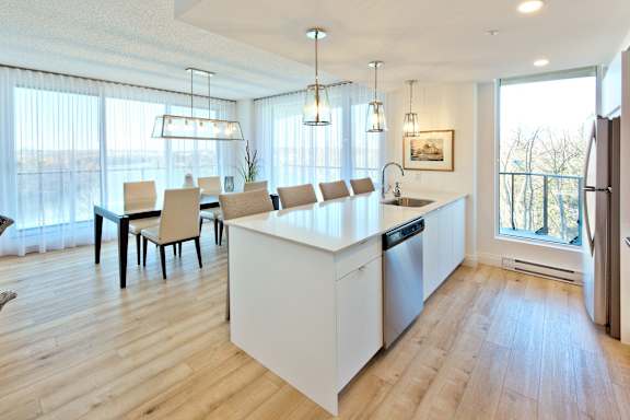 A modern kitchen with a dining table and chairs.