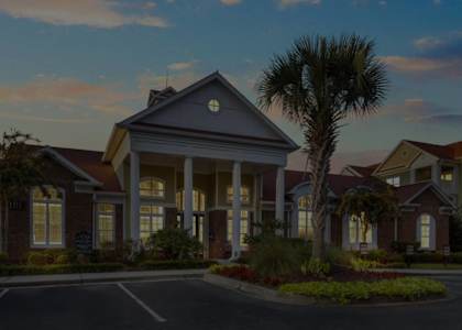 a rendering of a building with a palm tree in front of it at Breakers Point, South Carolina, 29579