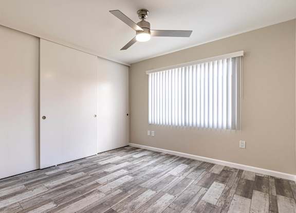 an empty living room with a ceiling fan and a window at Colima Terrace Apts, Rowland Heights, CA