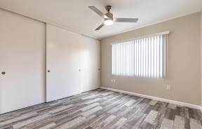 an empty living room with a ceiling fan and a window at Colima Terrace Apts, Rowland Heights, CA