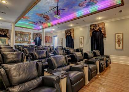 A row of black leather chairs are lined up in a room.