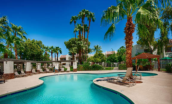 Resort-Style Pool Area with Palm Trees, Lounge Chairs, and a Cabana at Monaco at McCormick Ranch, Scottsdale, AZ 85258
