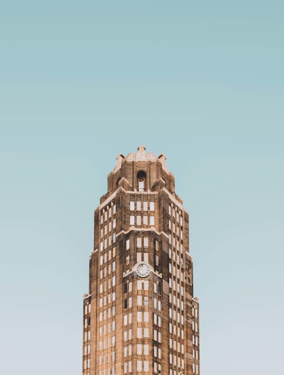 A tall building with a clock on the side.
