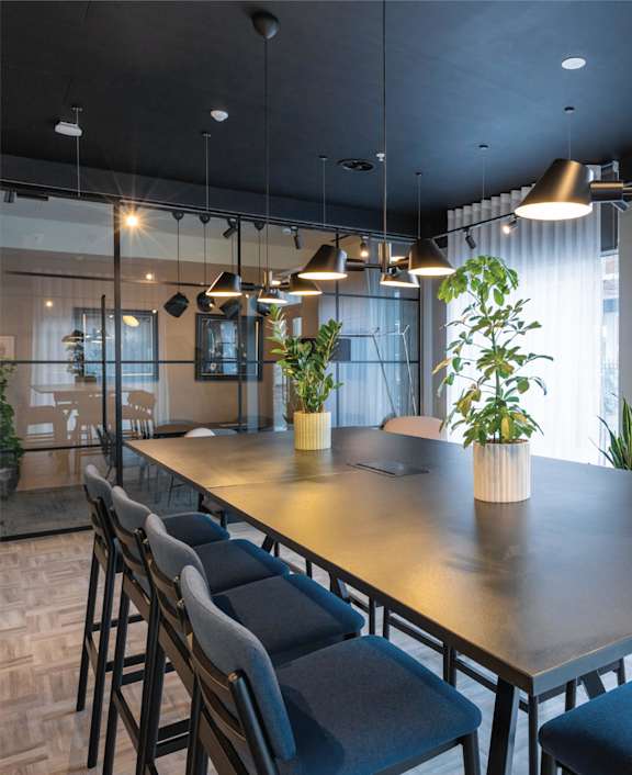 a conference room with a long table and chairs