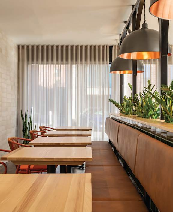 an empty meeting room with chairs and a long table