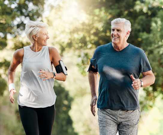 an older couple walking in the park at Village Oaks Apartments, Austin, Texas