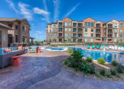 Thumbnail 9 of 78 - a resort style swimming pool with lounge chairs and chaise lounge chairs  at EdgeWater at City Center, Kansas, 66219