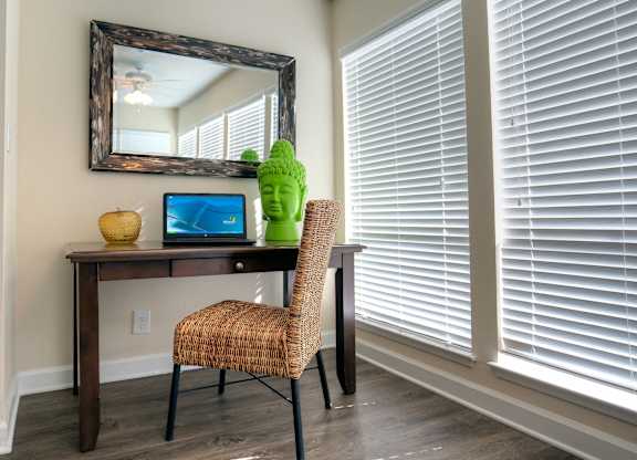 A cozy nook in the sunroom is at the ready for work from home.
