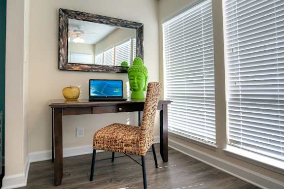 A cozy nook in the sunroom is at the ready for work from home.
