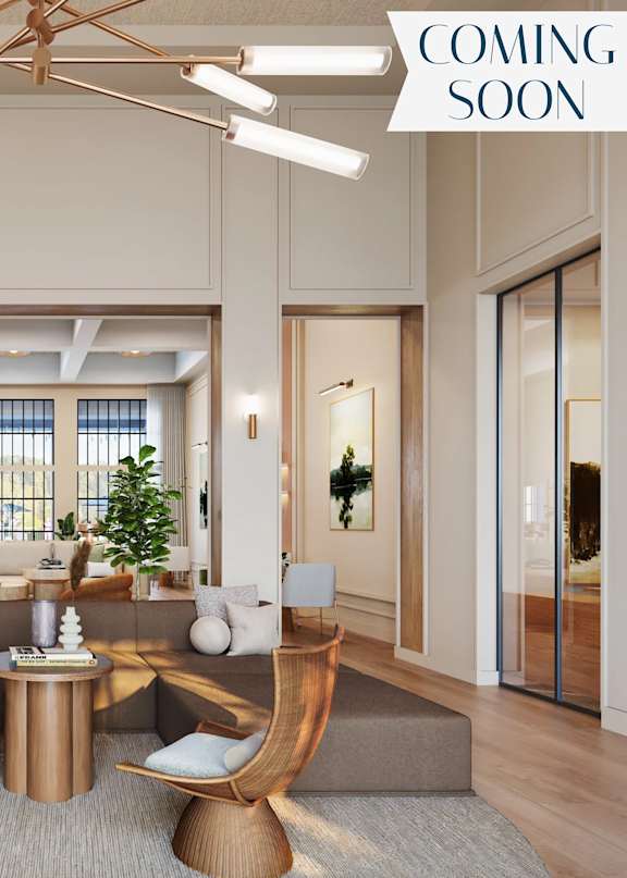 A modern living room with a large window and a "Coming Soon" sign.