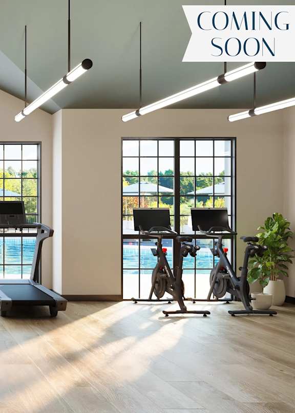 A gym with treadmills and a sign that says "coming soon".