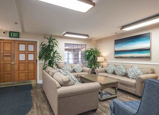 a living room with couches and chairs and a table at Huntington Terrace North Senior, Huntington Beach