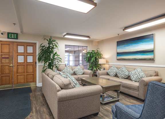 a living room with couches and chairs and a table at Huntington Terrace North Senior, Huntington Beach