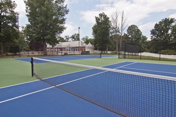 a tennis court with a building in the background
