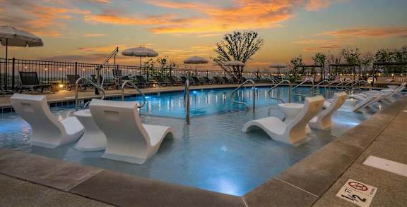 Outdoor swimming pool with cabanas at Encore at Brentwood apartments in Brentwood, Tennessee.