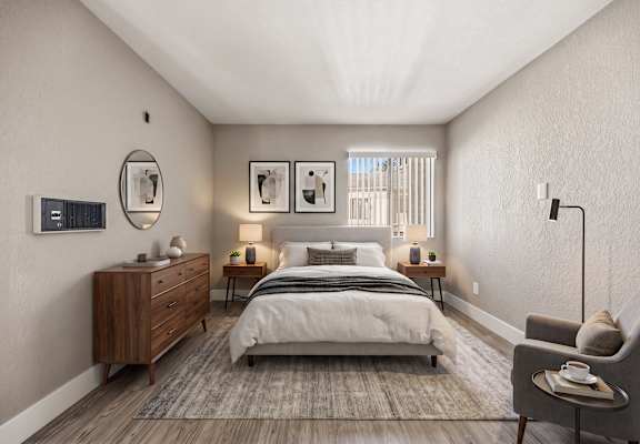 A bedroom with a large bed, a wooden dresser, and a chair.