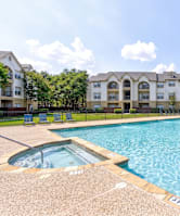 A large swimming pool surrounded by palm trees.