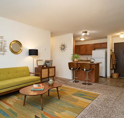 A living room with a green couch and a coffee table.