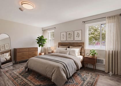 A bedroom with a large bed, a dresser, and a mirror.