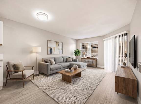 A bedroom with a bed, nightstands, and a painting on the wall. at Chamoune Senior Apartments, Apartments, San Diego, CA