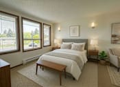 Thumbnail 3 of 8 - A bedroom with a large bed, a chair, and a window with blinds.