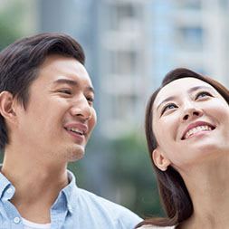 a man and a woman are looking up at the sky