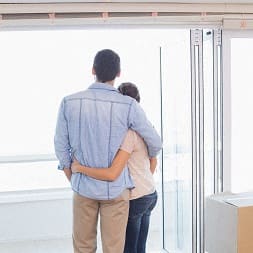 a man and a woman standing in front of a door